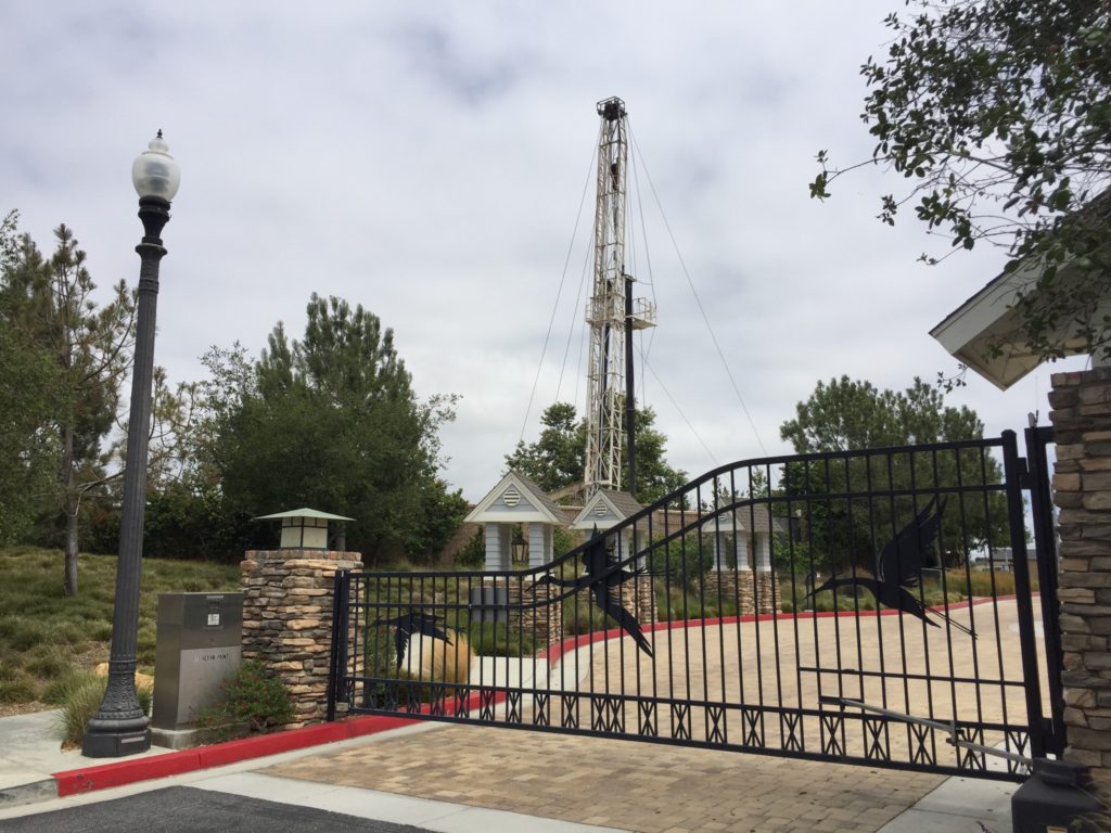 Seal Beach Oil Field Well: A demonstration of how the oil and gas industry is co-existing with an urban environment. Here a workover rig is performing well maintenance adjacent to a community with homes worth $1.1 million - $2.5 million.